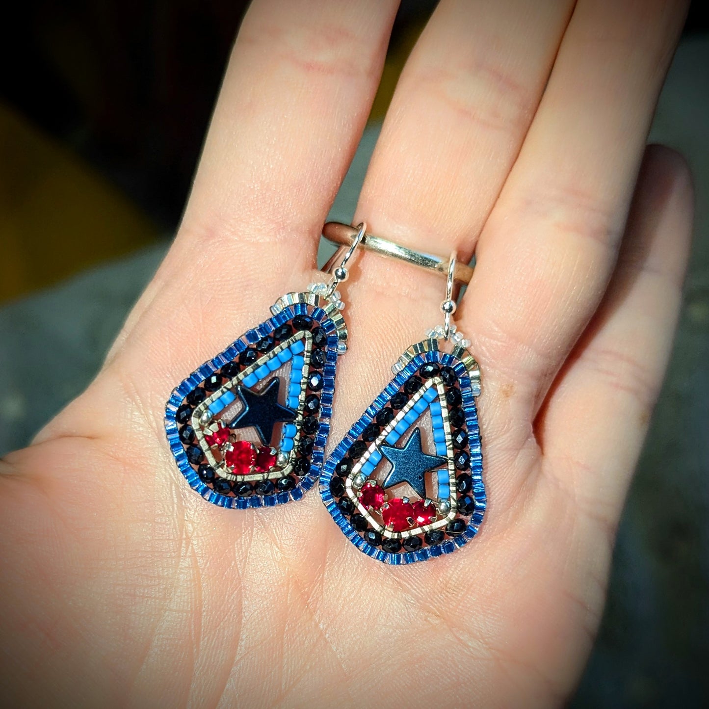 Texas inspired little drops with blue hematite stars, and Swarovski red. On sterling hooks or studs