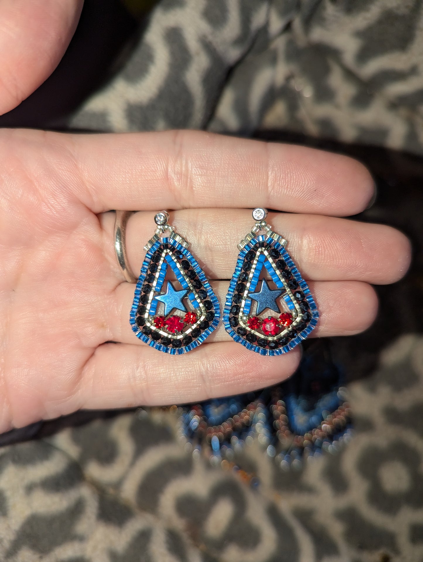 Texas inspired little drops with blue hematite stars, and Swarovski red. On sterling hooks or studs