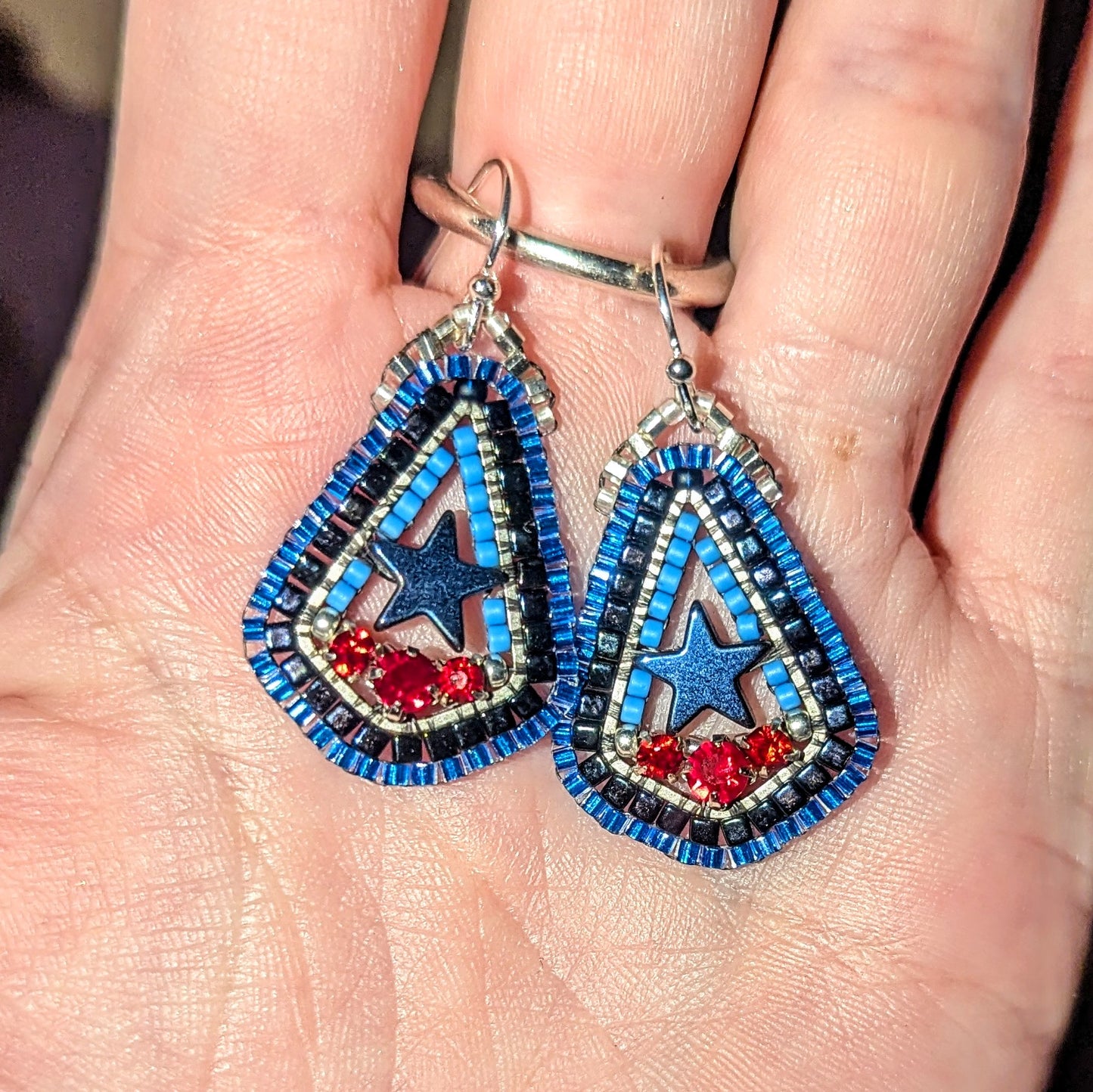 Texas inspired little drops with blue hematite stars, and Swarovski red. On sterling hooks or studs