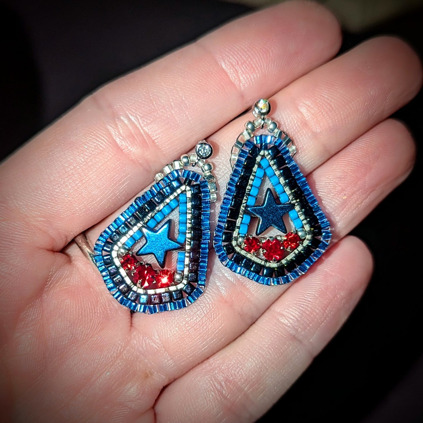Texas inspired little drops with blue hematite stars, and Swarovski red. On sterling hooks or studs