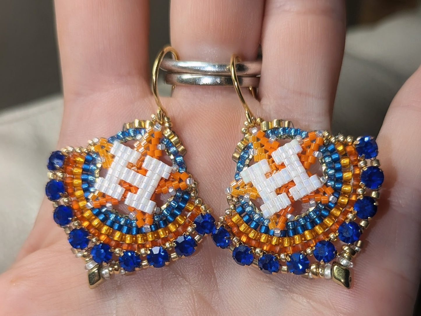 Round gold dangle with beautiful bright blue crystal montees, on gold plated sterling silver hooks.