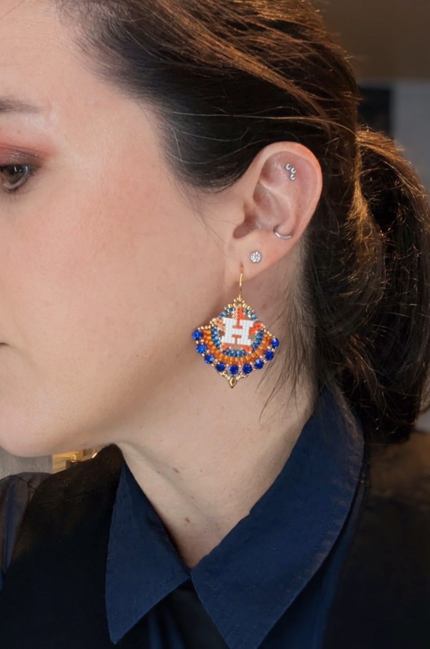 Round gold dangle with beautiful bright blue crystal montees, on gold plated sterling silver hooks.