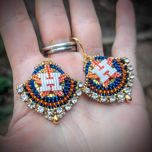 Round gold, blue, and orange dangles with beautiful white crystal montees, on gold plated sterling silver hooks.
