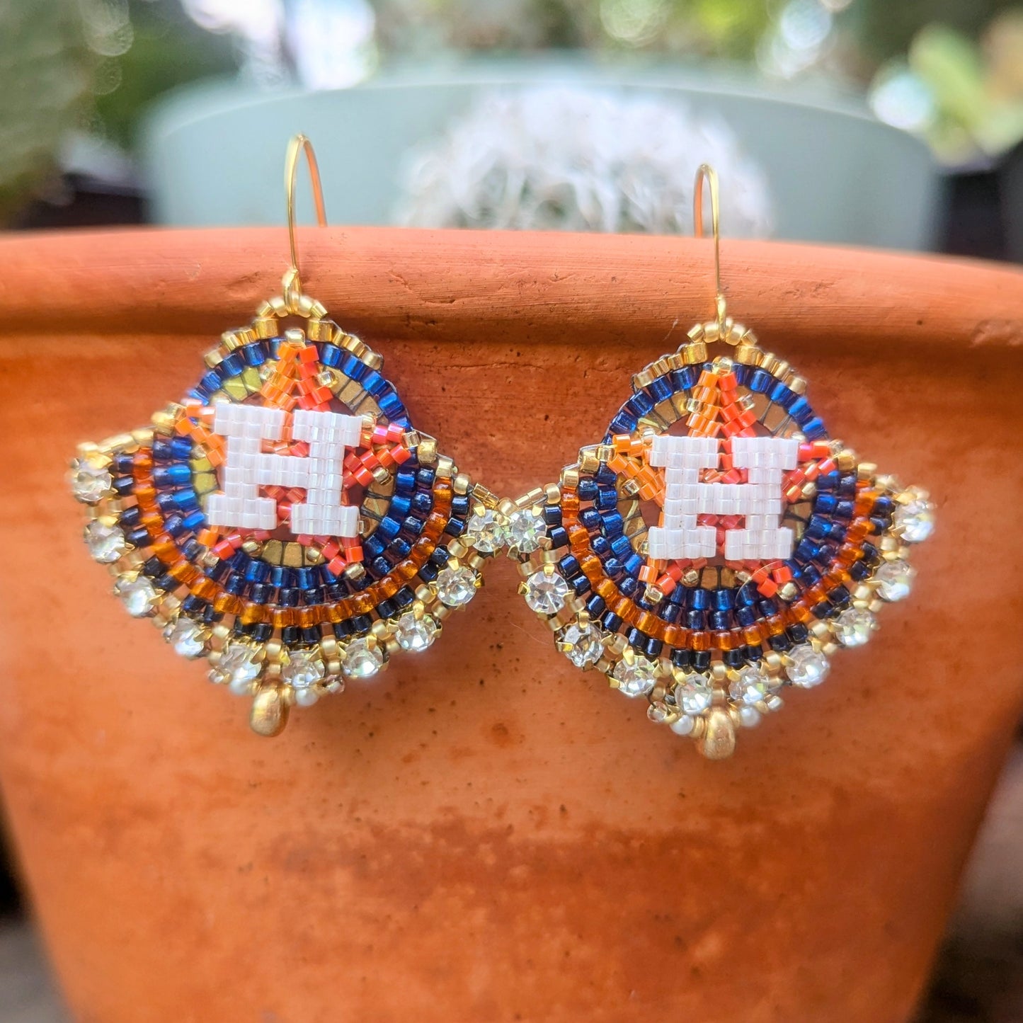 Round gold, blue, and orange dangles with beautiful white crystal montees, on gold plated sterling silver hooks.