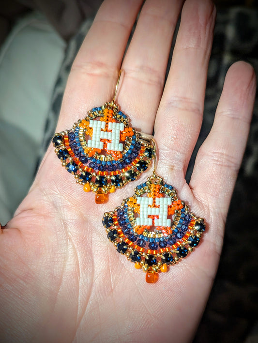 Round gold and blue dangles with beautiful blue crystal montees, on gold plated sterling silver hooks.